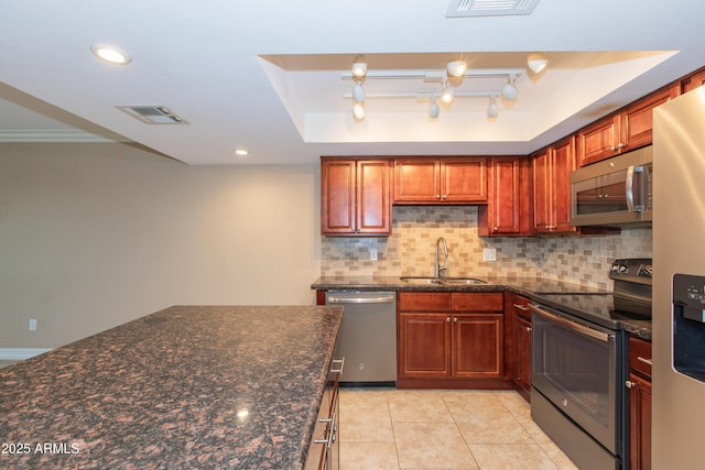 7970 E Camelback Rd Unit 604, Scottsdale, AZ 85251 - kitchen featuring appliances with stainless steel finishes, a sink, tasteful backsplash, a tray ceiling, and recessed lighting
