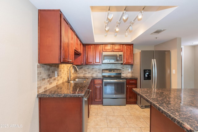 7970 E Camelback Rd Unit 604, Scottsdale, AZ 85251 - kitchen with stainless steel appliances, a sink, tasteful backsplash, dark stone counters, and light tile patterned floors