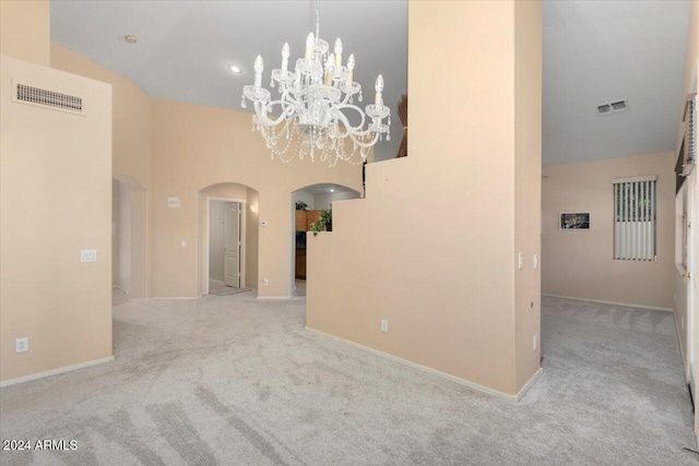 carpeted empty room featuring high vaulted ceiling