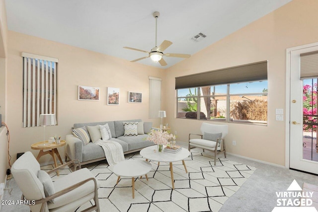 living room featuring light carpet, vaulted ceiling, and ceiling fan