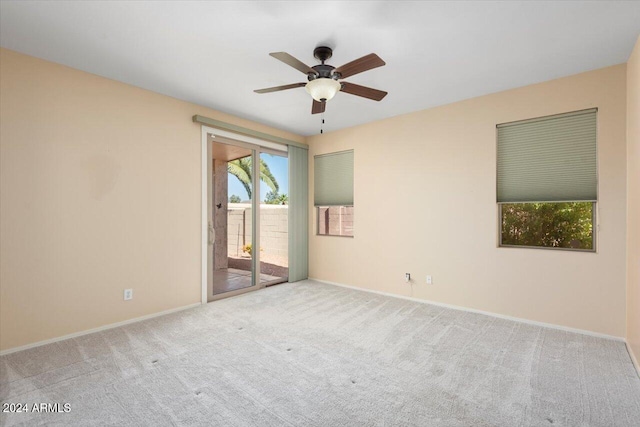 empty room featuring light carpet and ceiling fan