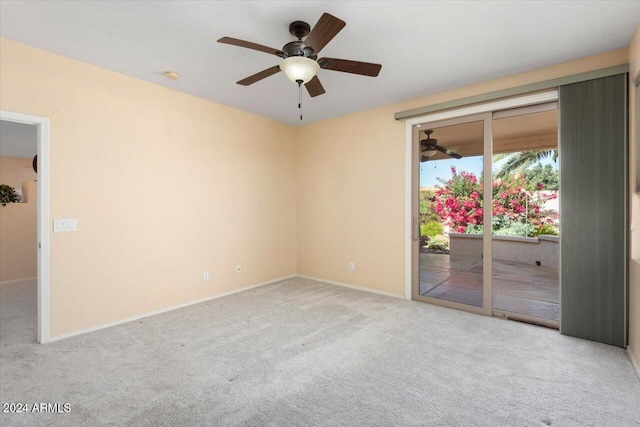 carpeted empty room featuring ceiling fan