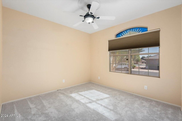 carpeted empty room with ceiling fan