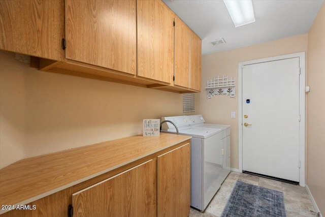 laundry area with cabinets and washer and clothes dryer