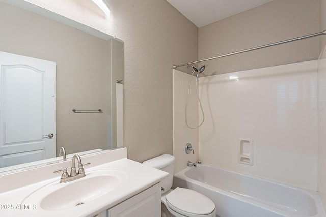 full bathroom with vanity, bathing tub / shower combination, toilet, and a textured wall