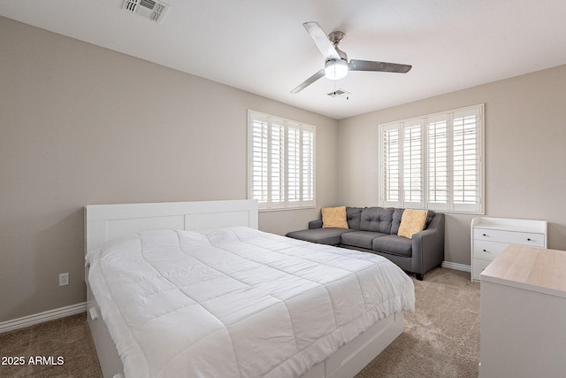 bedroom with visible vents, light carpet, and multiple windows