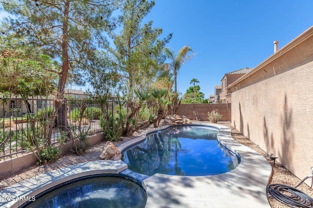 view of pool featuring an in ground hot tub