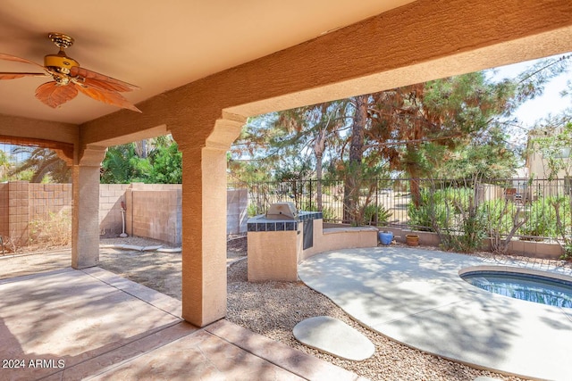 view of patio / terrace with ceiling fan and an outdoor kitchen