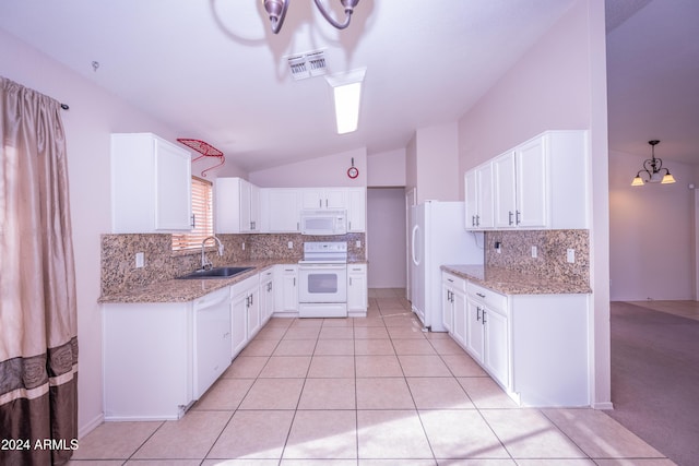 kitchen featuring vaulted ceiling, white cabinetry, sink, and white appliances