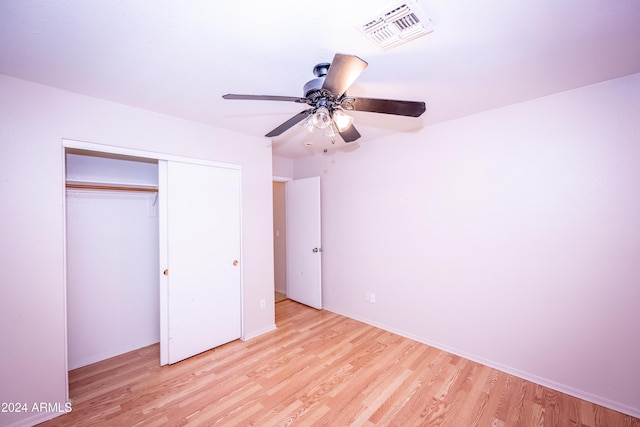 unfurnished bedroom with a closet, light hardwood / wood-style flooring, and ceiling fan