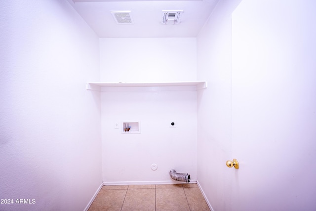 laundry room featuring hookup for a washing machine, gas dryer hookup, electric dryer hookup, and light tile patterned flooring