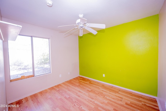 unfurnished room featuring a wealth of natural light, ceiling fan, and light hardwood / wood-style floors