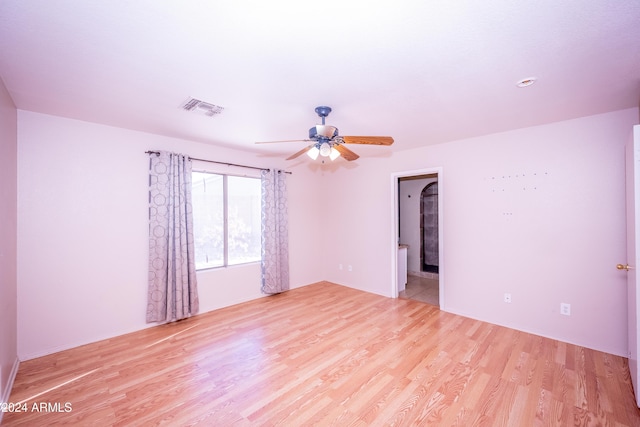 spare room featuring light hardwood / wood-style floors and ceiling fan