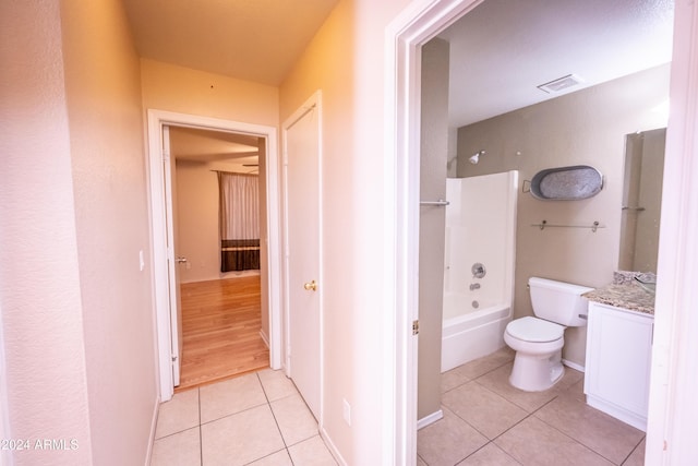 full bathroom featuring shower / tub combination, tile patterned flooring, vanity, and toilet