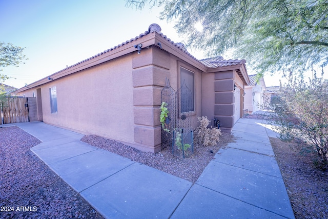 view of side of home featuring a garage