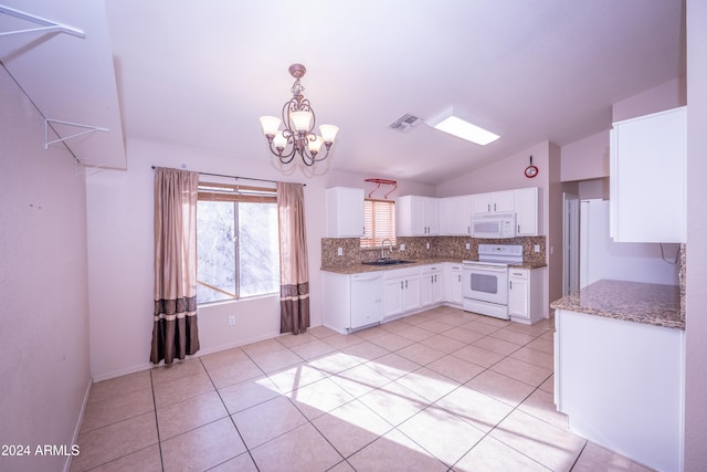 kitchen with pendant lighting, lofted ceiling, white appliances, sink, and white cabinetry