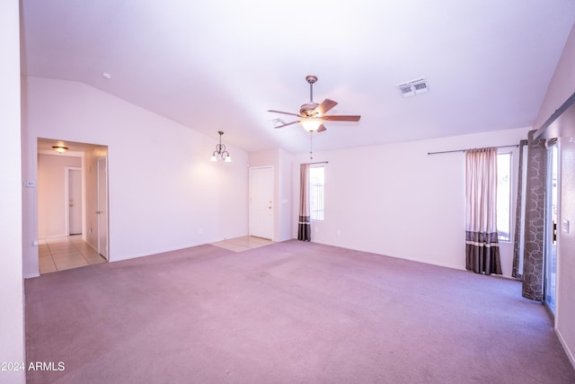 unfurnished room featuring ceiling fan with notable chandelier, light colored carpet, and lofted ceiling