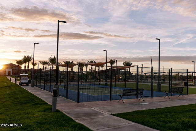 view of home's community featuring a yard and tennis court