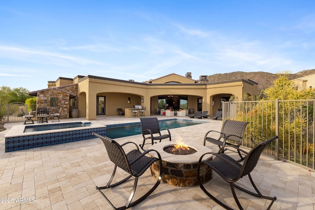3553 N Crystal Peak Cir, Mesa, AZ 85207 - view of swimming pool featuring a pool with connected hot tub, a patio area, fence, a mountain view, and an outdoor fire pit