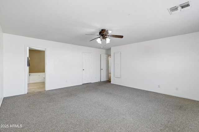 interior space with visible vents, carpet flooring, ensuite bathroom, and ceiling fan