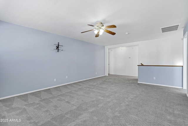 empty room featuring baseboards, carpet, visible vents, and ceiling fan