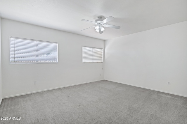 spare room featuring baseboards, carpet, and a ceiling fan