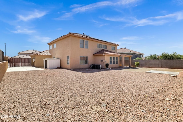 rear view of property featuring a fenced backyard, stucco siding, and a patio