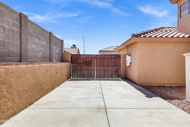 view of patio / terrace featuring fence and a gate