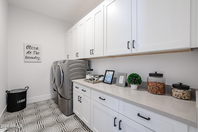 washroom featuring cabinets and washer and dryer