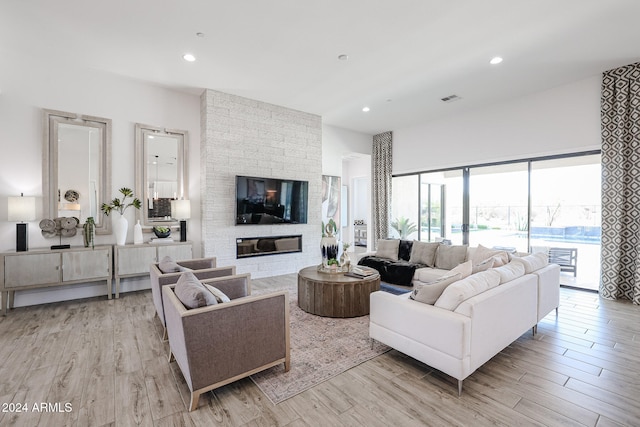 living room featuring a fireplace and light hardwood / wood-style floors