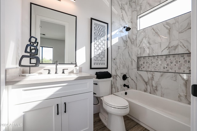 full bathroom with vanity, toilet, hardwood / wood-style floors, and tiled shower / bath