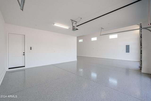 garage featuring a garage door opener and electric panel