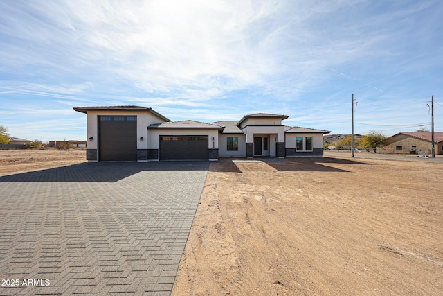 prairie-style home featuring a garage