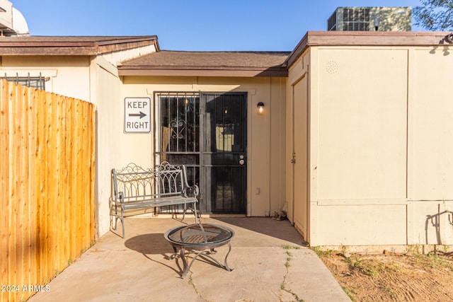 view of exterior entry with a patio area