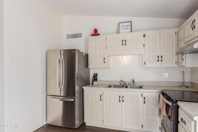 kitchen featuring white cabinets, sink, vaulted ceiling, appliances with stainless steel finishes, and dark hardwood / wood-style flooring