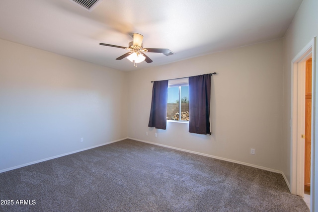 carpeted empty room with visible vents, baseboards, and a ceiling fan