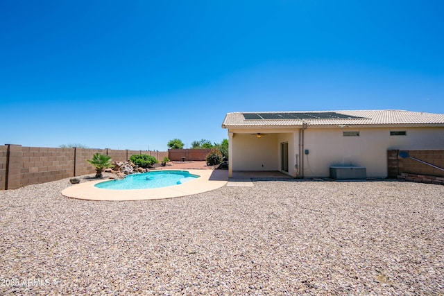 view of swimming pool featuring a ceiling fan, a fenced in pool, a fenced backyard, and a patio