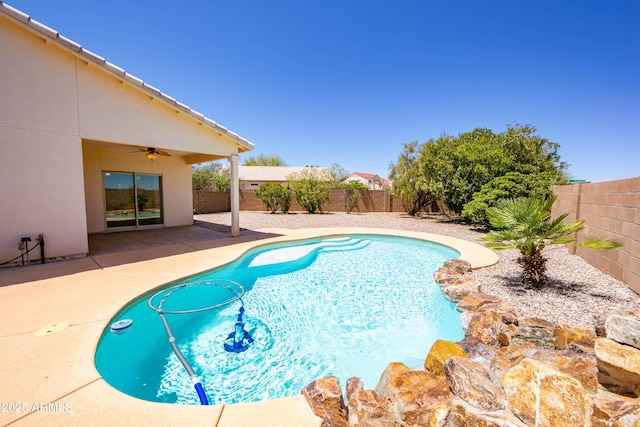 view of swimming pool featuring a fenced in pool, a patio area, a fenced backyard, and ceiling fan