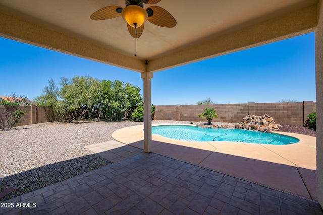 view of pool with a patio area, a fenced backyard, a fenced in pool, and a ceiling fan