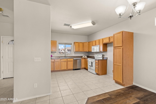 kitchen featuring a chandelier, white appliances, light tile patterned floors, and visible vents