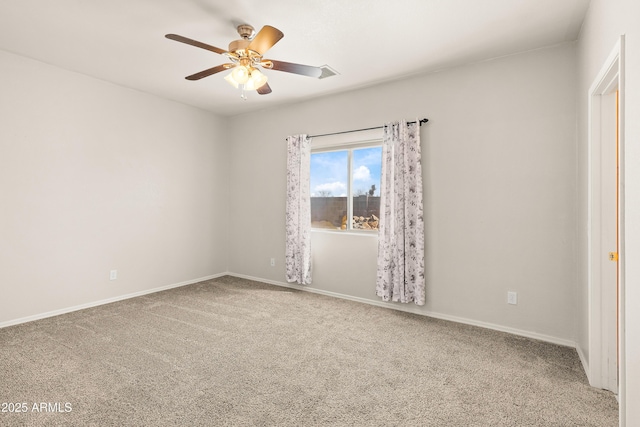 spare room featuring carpet flooring, a ceiling fan, and baseboards