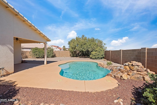 view of pool with a fenced in pool, a patio area, a fenced backyard, and a ceiling fan