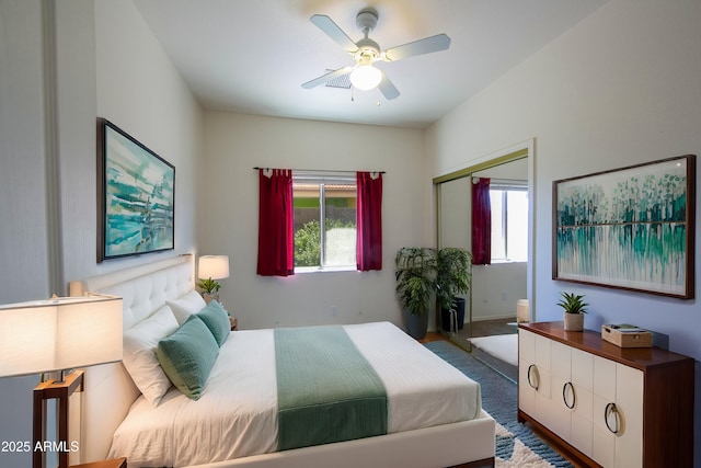 bedroom with ceiling fan and a closet