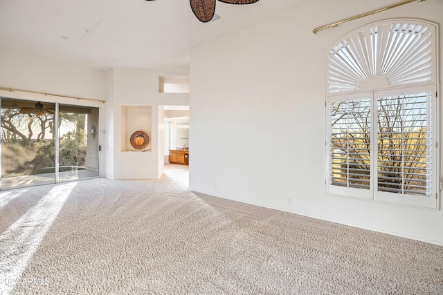 spare room with carpet flooring and ceiling fan