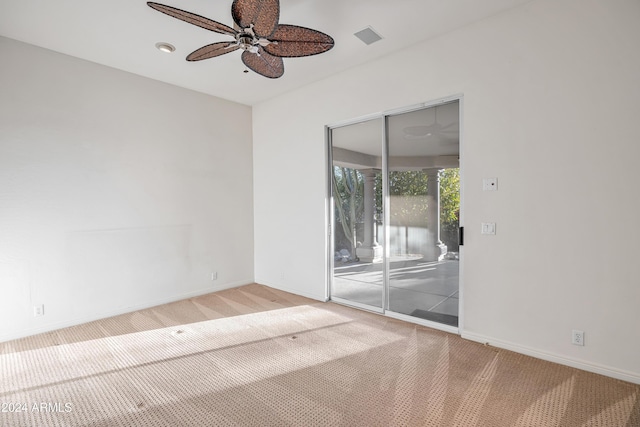 unfurnished room featuring ceiling fan and carpet floors