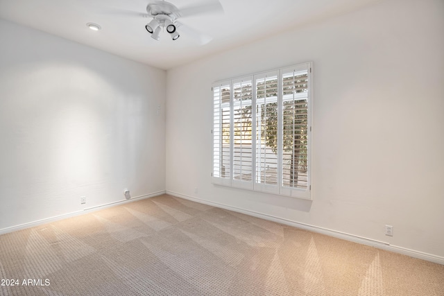 unfurnished room with ceiling fan and light colored carpet