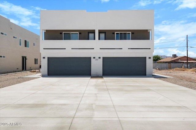 2559 E Broadway Rd, Phoenix, AZ 85040 - view of front of home featuring a garage, stucco siding, and concrete driveway