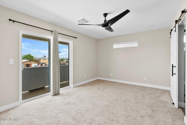 2559 E Broadway Rd, Phoenix, AZ 85040 - unfurnished bedroom featuring a barn door, access to exterior, multiple windows, and carpet floors