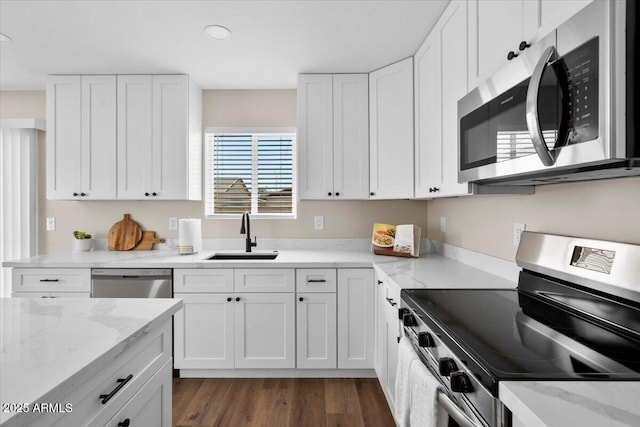 2559 E Broadway Rd, Phoenix, AZ 85040 - kitchen featuring stainless steel appliances, white cabinets, dark wood-style floors, light stone counters, and recessed lighting