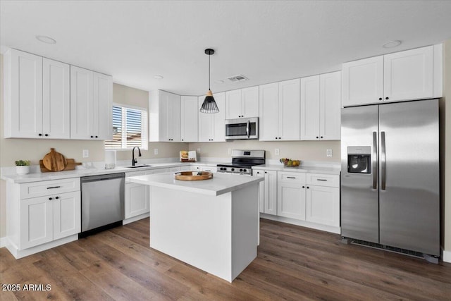 2559 E Broadway Rd, Phoenix, AZ 85040 - kitchen featuring stainless steel appliances, white cabinetry, light countertops, and dark wood finished floors